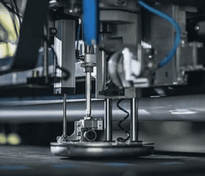 Agility and Savings in the Cutting Process of your Apparel Company 7 Close-up of automated cutting system of a high-precision textile machine with industrial components and sensors